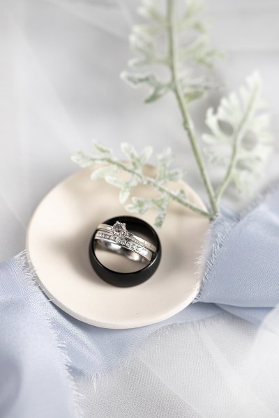 Detail wedding ring photo on ring dish and blue ribbon.  Photo taken by Photography by Justine Bismarck wedding photographer ring shot