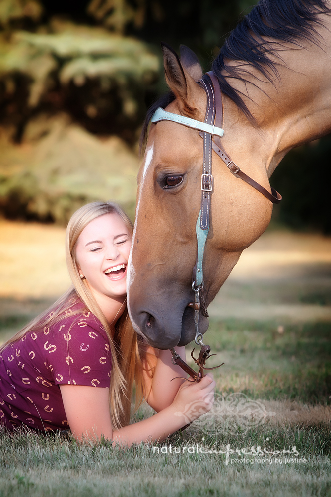 close up of senior girl with horse and laughing