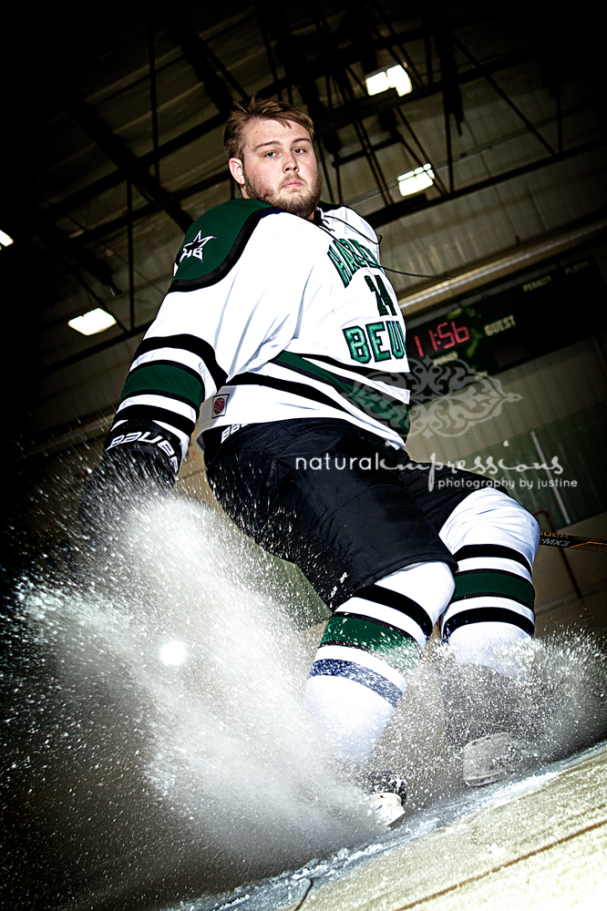 senior hockey player sprays ice