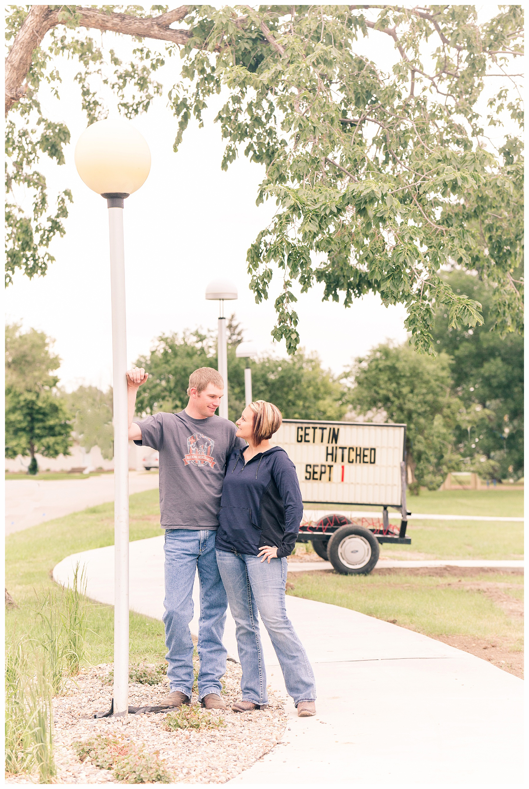 Engagement pictures with a sign