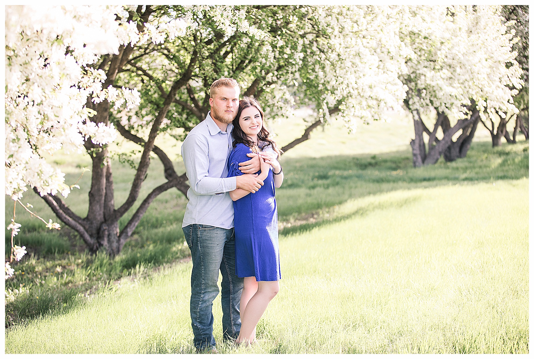 Spring engagement pictures by flowering white trees