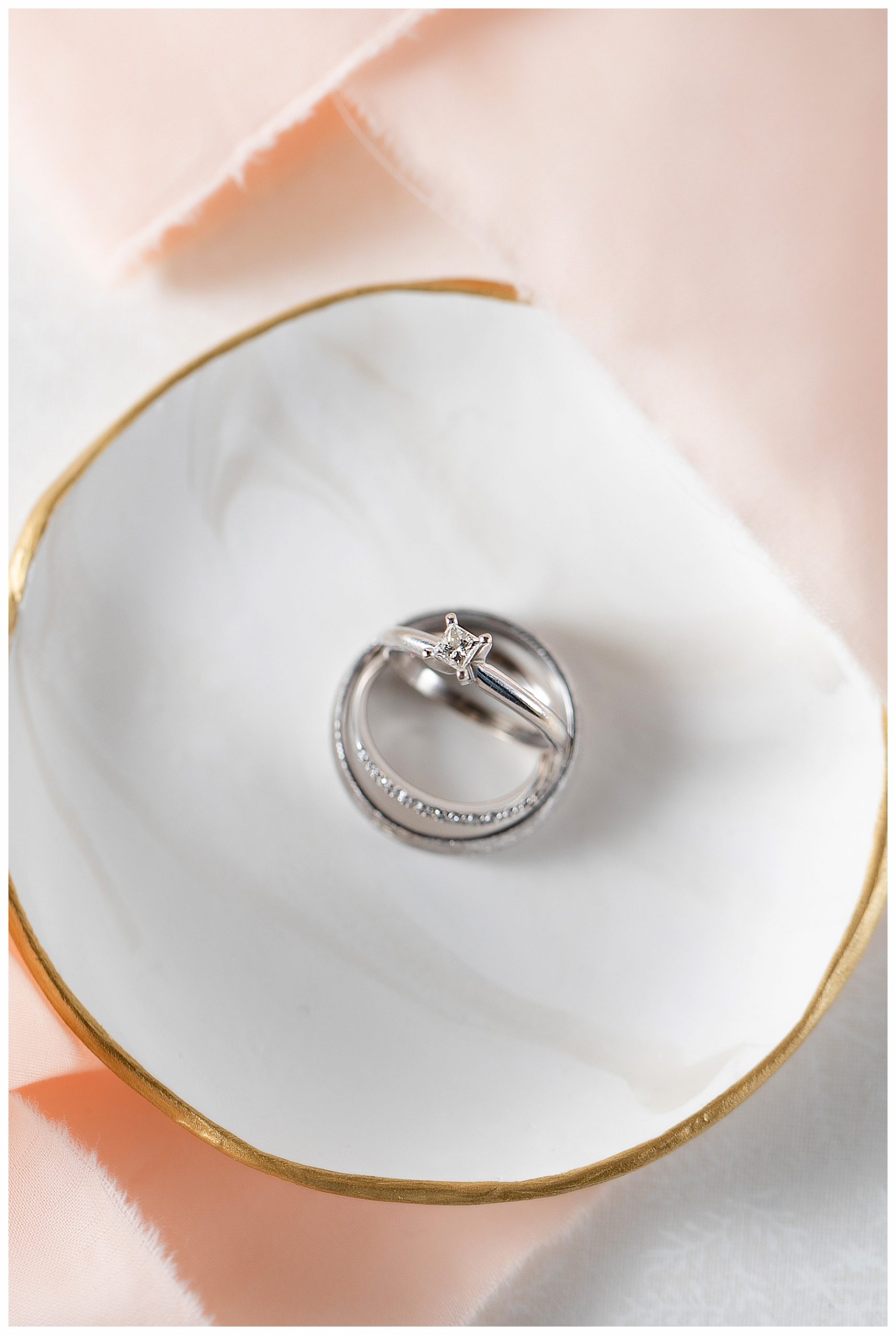 wedding ring detail photo with peach ribbon