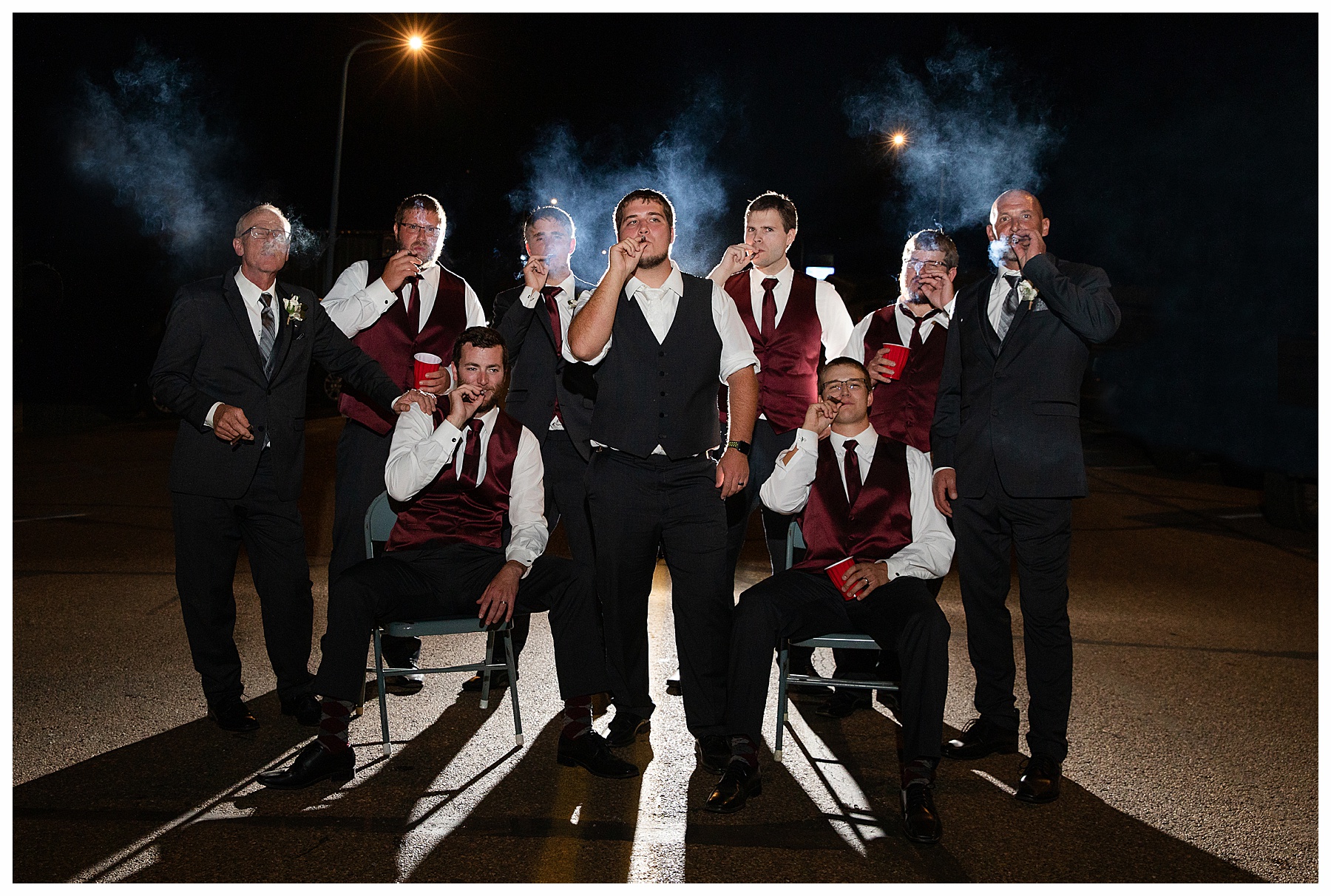 groom and groomsmen cigar picture at night