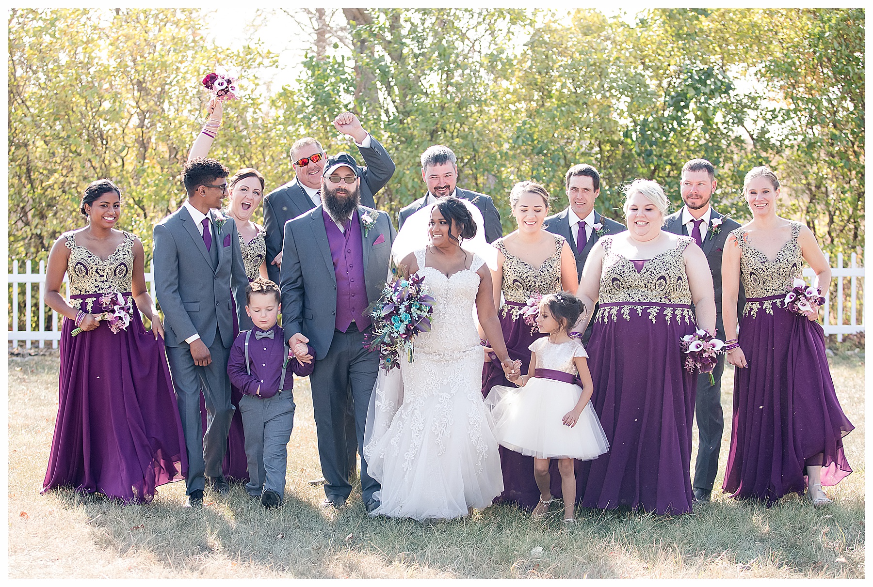 wedding party in purple and grey and gold walk and celebrate with high five