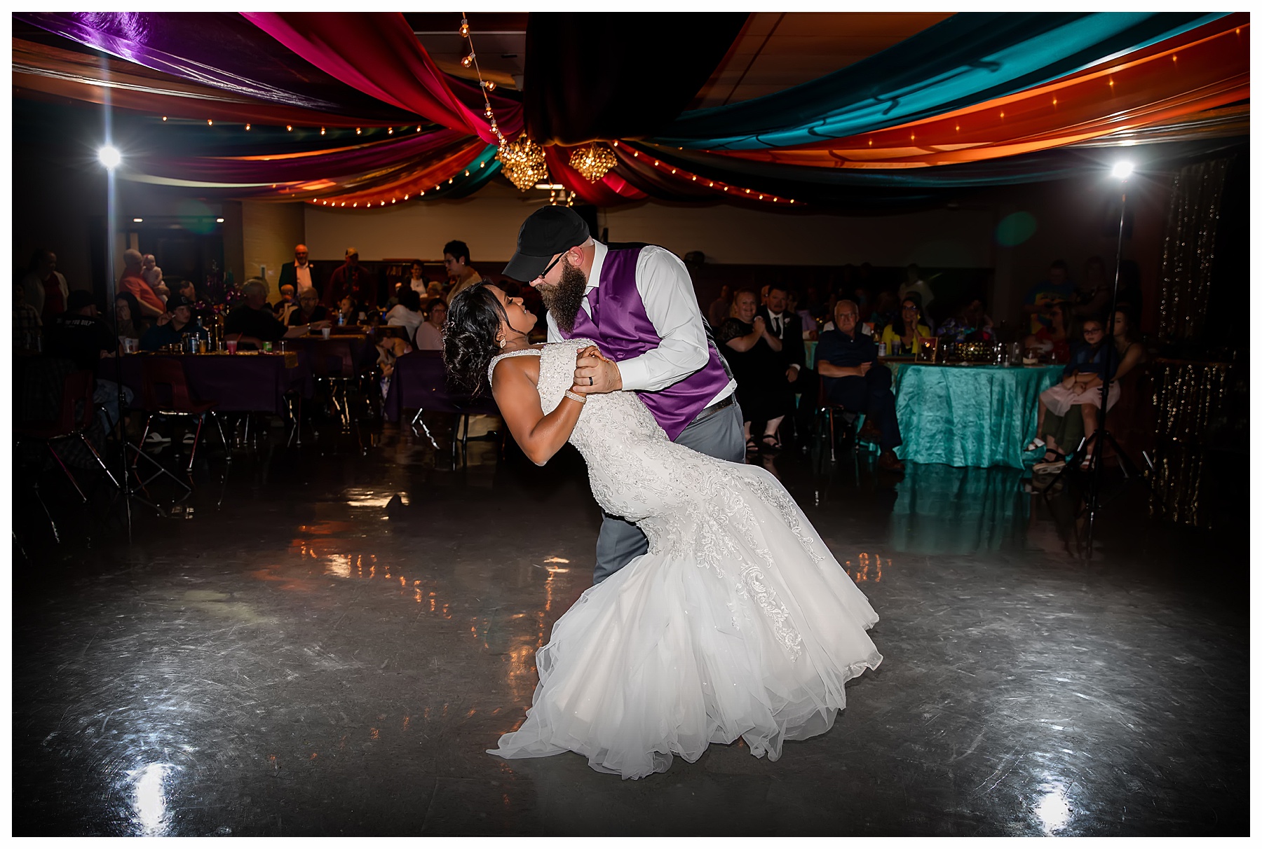 groom dips bride during first dance as husband and wife