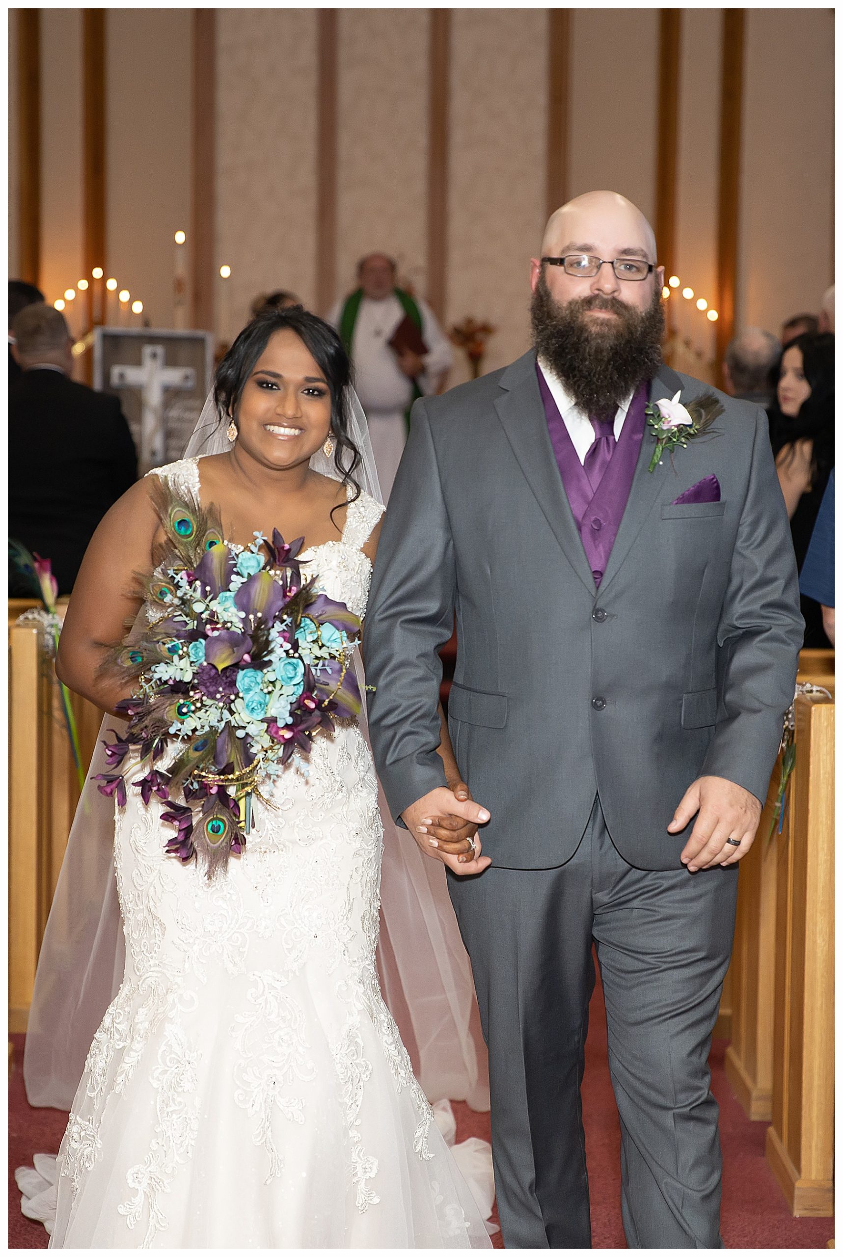 bride with peacock feather bouquet exit church after ceremony