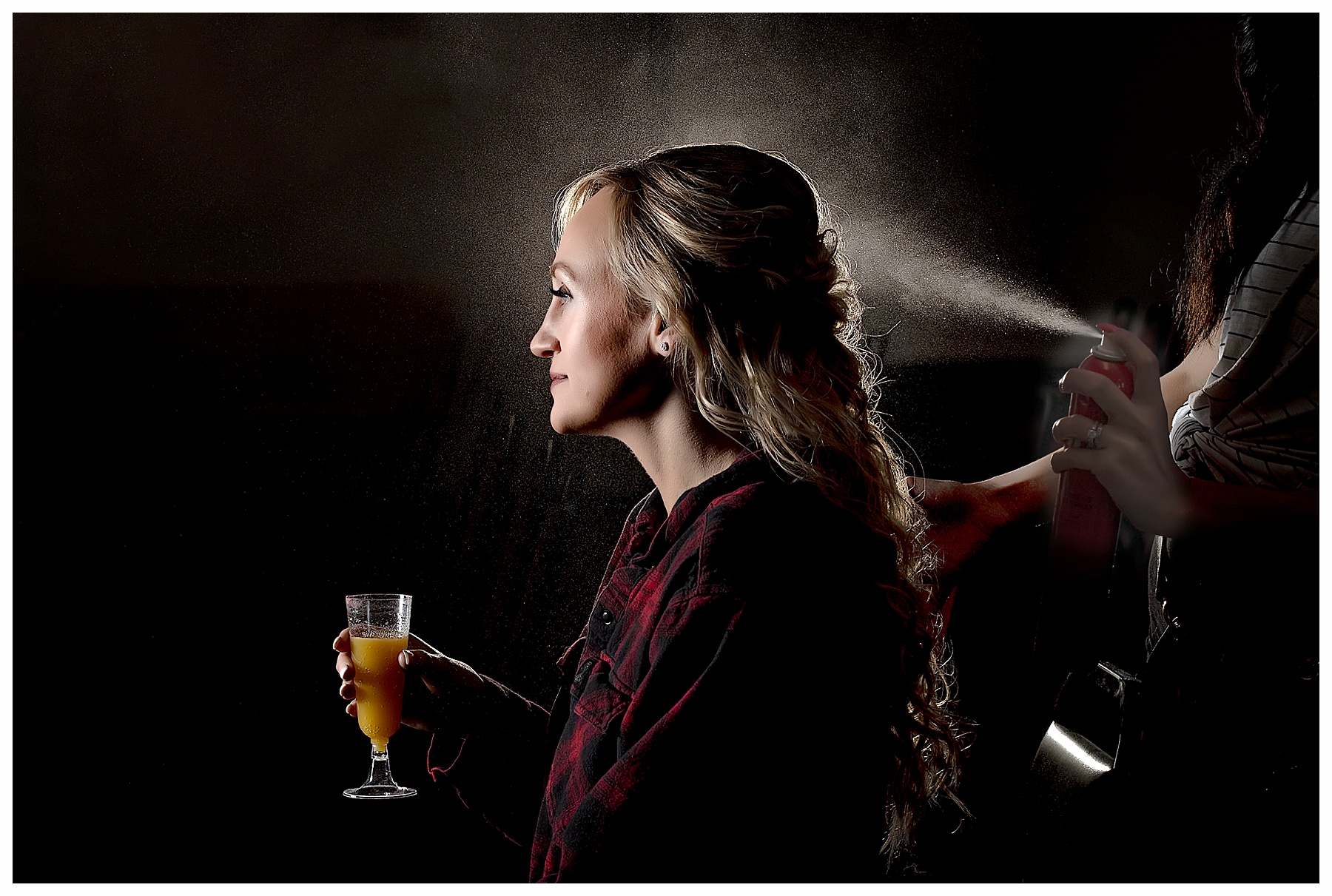 bride with mimosa getting her hair done and showing hair spray mist