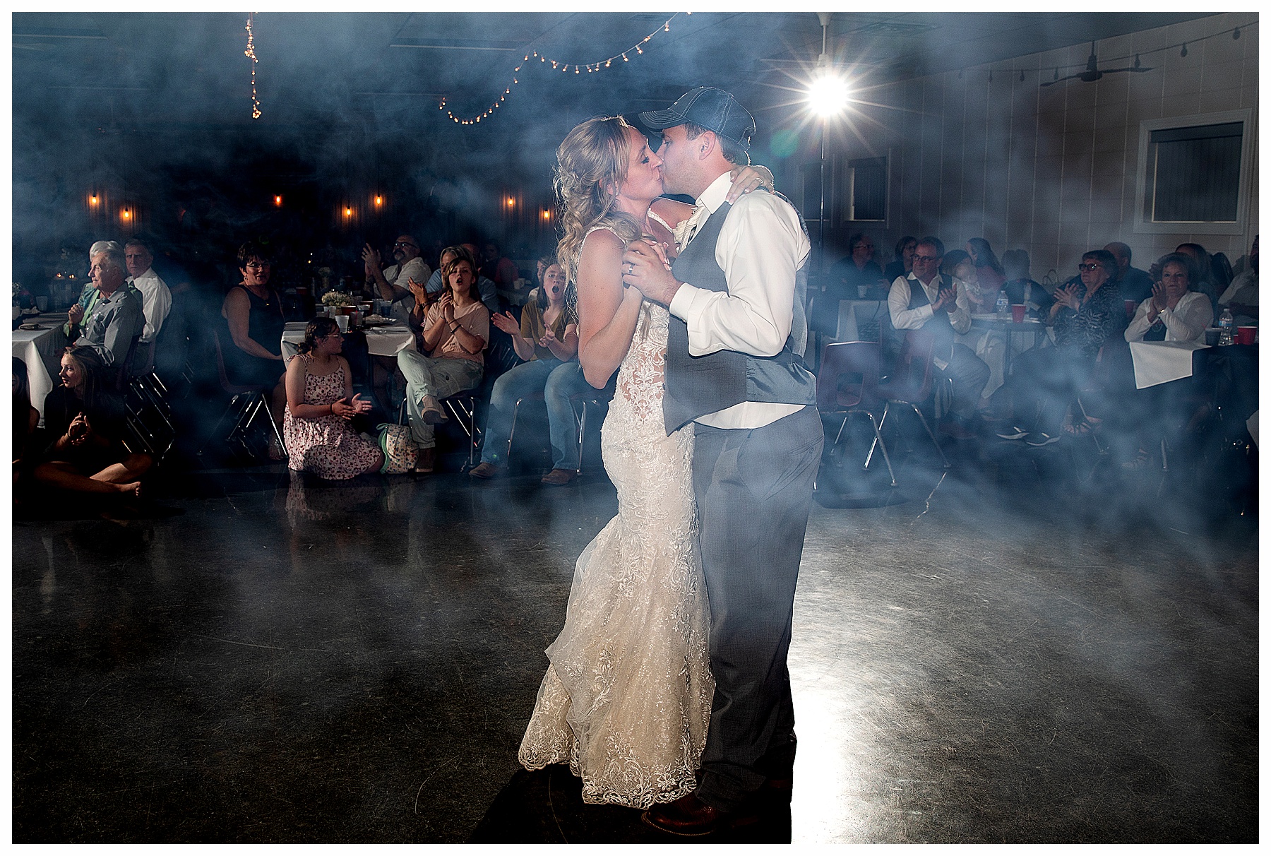 bride and groom kiss during first dance with fog at North Dakota May Wedding