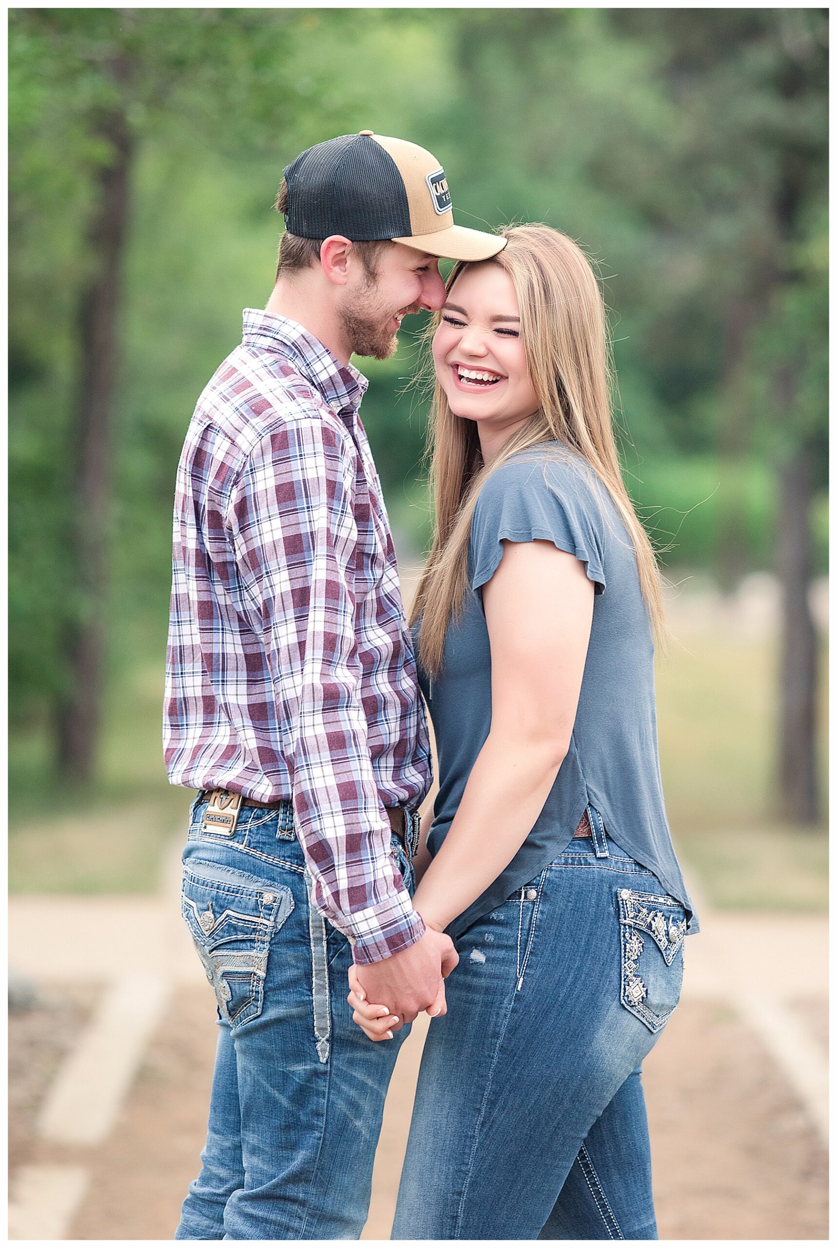 couple laughs during engagement pictures session