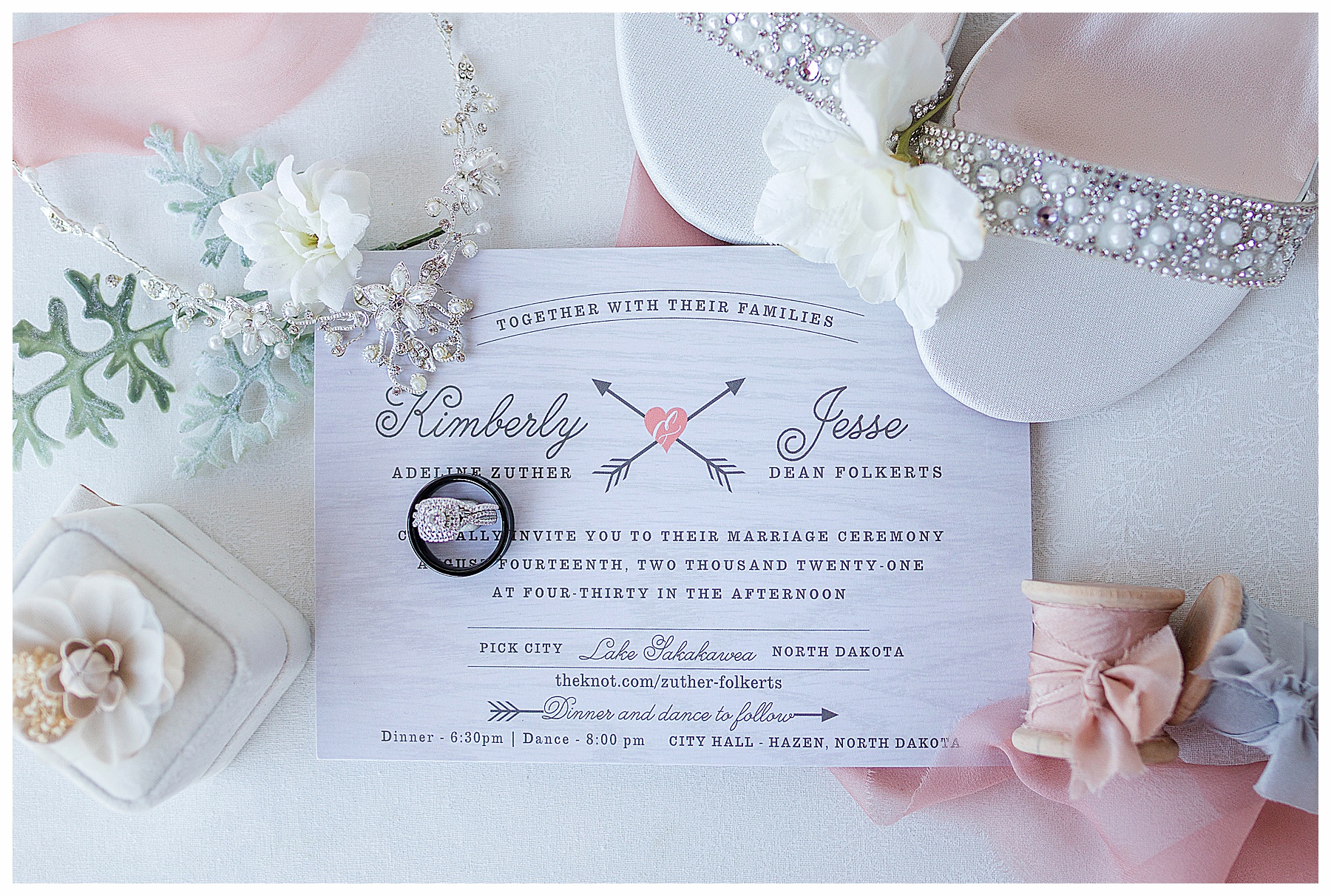 Wedding details photo showing invitation, rings, shoes and necklace
