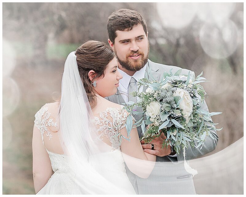 Bride and Groom look into the distance white hazy look