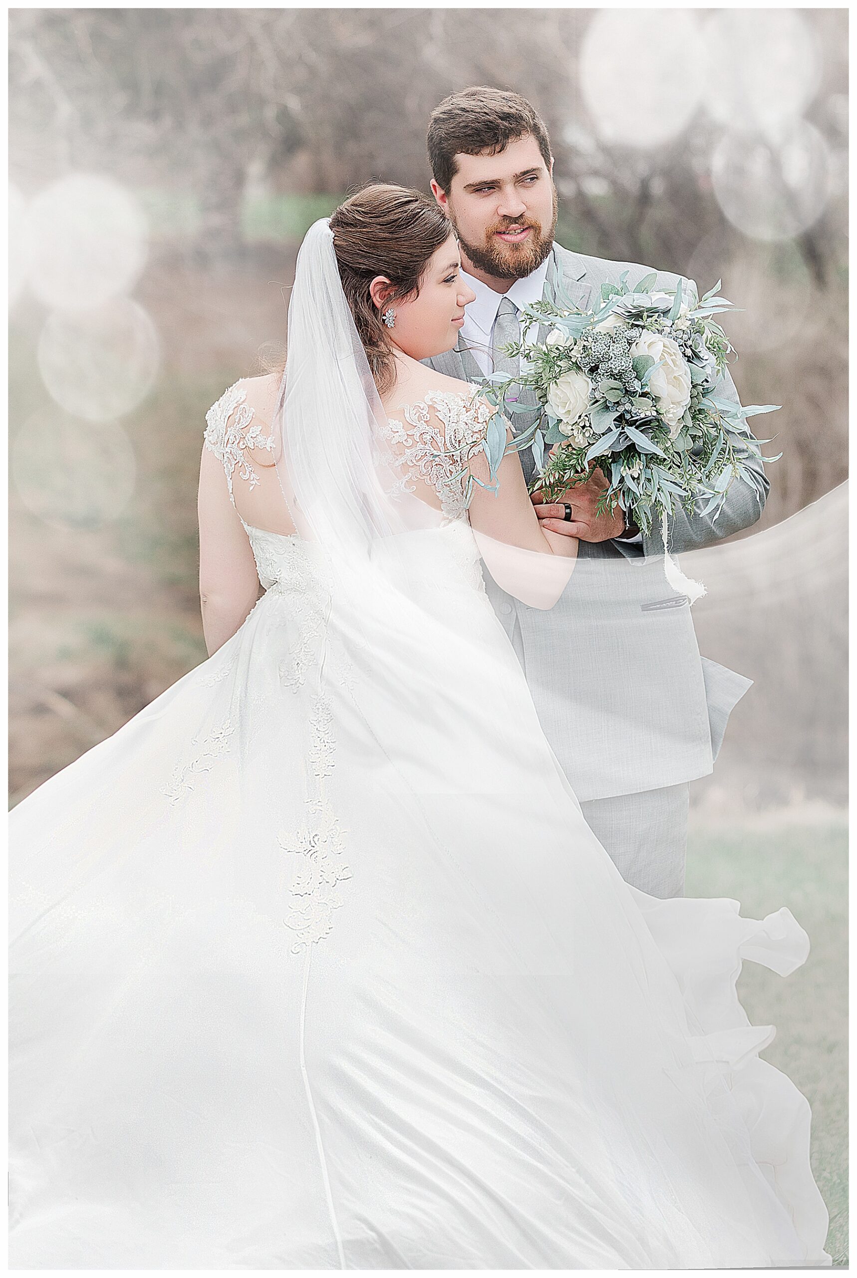 dreamy bride and groom.  bride wearing cathedral veil and blue and green succulent bouquet
