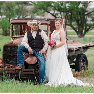 Bride and Groom pose with old vintage rusty truck