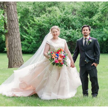 Bride and Groom holding hands and gown blowing in the wind