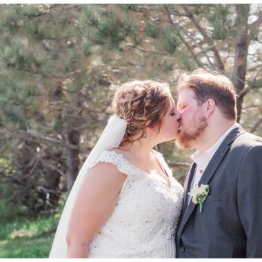 bride and groom kissing on a sunny wedding day