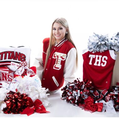 Senior Girl posing with her cheerleading uniforms and moms